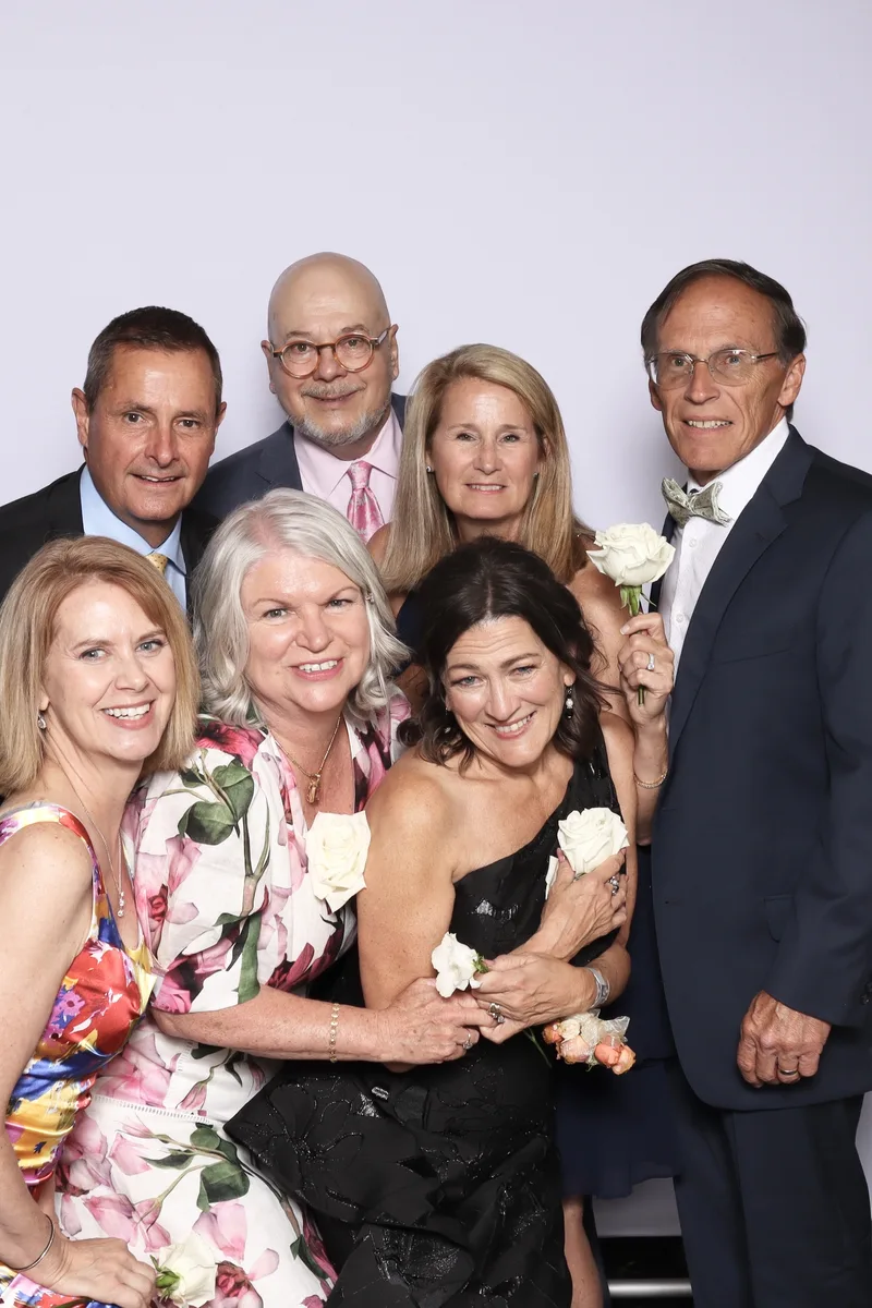 A whole family dressed up and laughing together in the booth