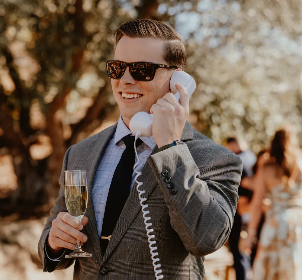 A wedding guest leaving a message on the vintage rotary phone audio guest book