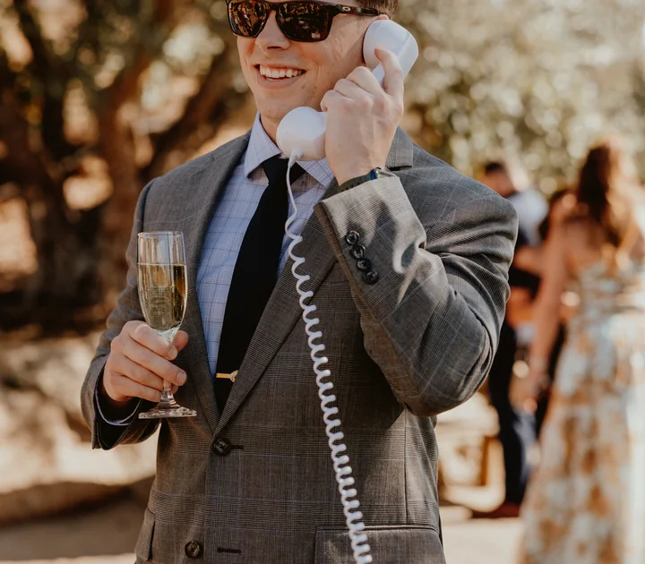 A wedding guest leaving a message on the vintage rotary phone audio guest book