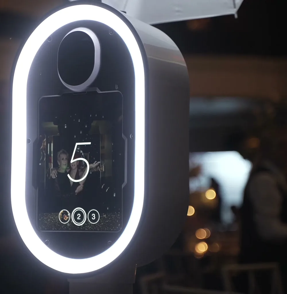 The photo booth screen counting down to a shot inside its ring light